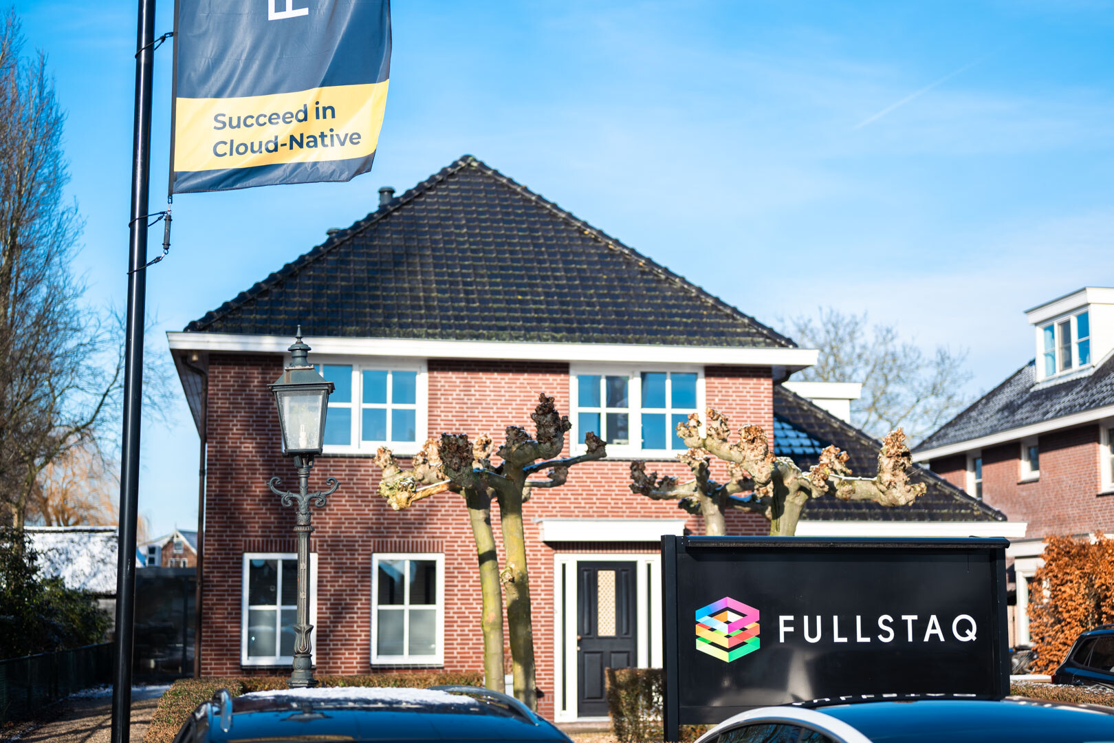 Fullstaq headquarters, a photograph of the office in Lemond, with the Fullstaq sign in front of it